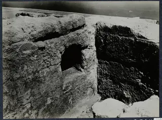 Rough stone masonry with a square recess at the palace at Vouni, with fallen stones in the foreground
