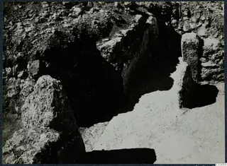 Large stone blocks exposed in a narrow excavated cutting at Vouni Palace