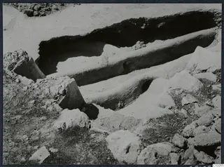 Excavation at Vouni palace with a long cut channel in pale earth and loose stones around it