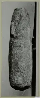 Tall, tapering stone vessel from Cyprus, standing upright against a grey backdrop.