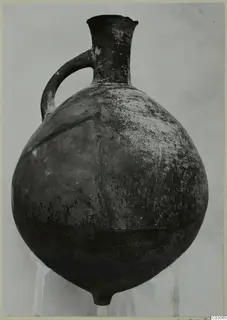 Pottery Black Slip Ware jug from Ayios Iakovos with a single loop handle and a flared neck