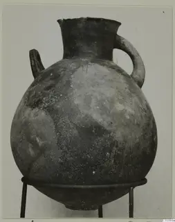 Black Slip Ware hydria: a globular vessel with a flaring neck and two handles, on a metal stand