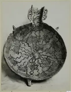 White Painted IV-V bowl from Ayios Iakovos with dark wavy painted decoration and a pierced lug handle