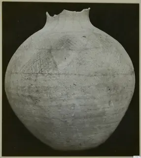 White Painted Wheel-made jar with a broken rim and faint crosshatched painted pattern on the shoulder