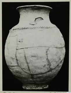 Jar in Plain White Hand-made Ware from the Karpas sites, with a band of impressed decoration below the neck