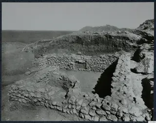Hellenistic house at Mersinaki, seen from the west, with stone walls and excavated earth behind