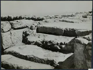 Ruined stone walls and large dressed blocks forming steps at the palace at Vouni