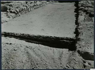 Excavated floor surface at the palace at Vouni, bounded by stone walls on two sides