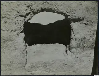 Rough pale stone wall with a rectangular opening at the palace at Vouni