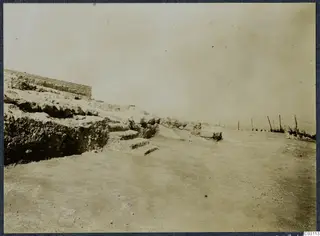Stone wall and stepped rock ledges at Vouni, with a wire fence on the right.
