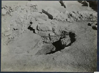 Excavation trench at Vouni Palace with piled stones and low walls