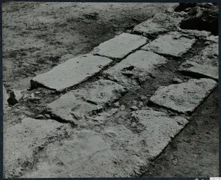 Excavated stone slabs forming a paved floor during excavation at the palace at Vouni