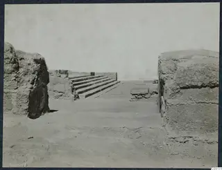 Ruined stone walls and a flight of stone steps at the palace at Vouni, seen from a low viewpoint.