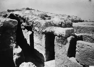 Excavated stone blocks and a narrow dark gap at the palace at Vouni