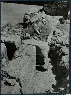 Excavated walls and large squared stone blocks in soil and rubble at the palace at Vouni