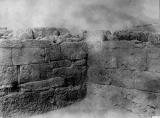 Excavated stone masonry wall at the palace at Vouni, with large squared blocks laid in courses.