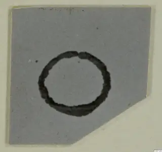 Ring-shaped object with a dark outline on a grey background, shown on a cut-corner card