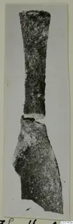 Corroded metal tool from Marion, with a long tapering shank above a broken, broader blade
