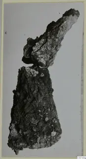 Two corroded iron tool fragments, find from tombs 31–45 at Marion, on a plain pale background