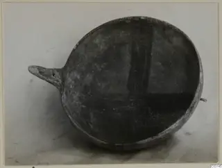Red-on-Black bowl from Ayios Iakovos with a pointed horizontal handle projecting to the left