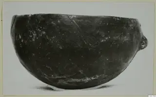 Pottery Red Polished I bowl from Lapithos, photographed in side view against a pale background.