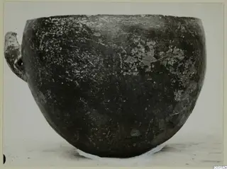 Pottery Red Polished III bowl from Lapithos, seen from the side, with a small handle on the left