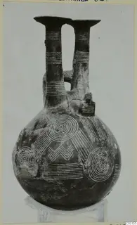 Pottery jug with two tall necks and concentric circle and chevron decoration, from Lapithos