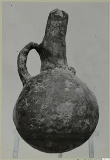 Red Polished III pottery jug from Lapithos, with a single loop handle and a tall neck