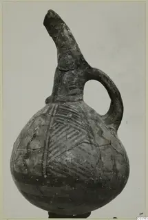 Jug with a tall broken spout and loop handle, painted with hatched bands, from Lapithos