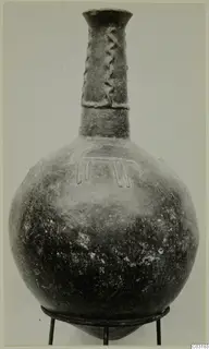 Pottery Red Polished II jug with a tall narrow neck and applied decoration, from Lapithos
