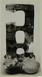 Incised pottery object with three rounded openings stacked vertically and two bowl-shaped sections at its base