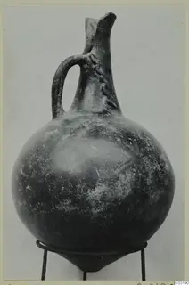 Red Polished I jug from Lapithos, with a strap handle and a pinched spout at the top