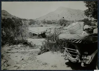 Gudrun Birgitta Atterman in a car beside the Limnitis bridge at Vouni, with hills behind.