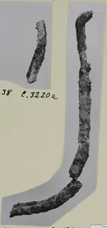 Corroded iron rods and fragments mounted on a grey card, with a handwritten label beside them
