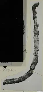Corroded metal object from Marion, a long curved piece shown on a photo mount with handwritten labels.