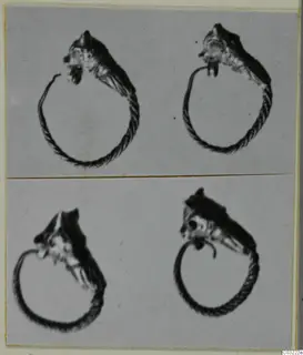 Four views of a gold twisted-wire ring with a head-shaped terminal, mounted on a grey card
