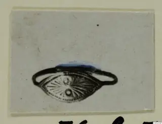 Finger ring with an oval bezel decorated with radiating lines and dots, from Marion
