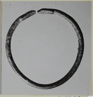 Silver bracelet, penannular, with flattened ends shaped like animal heads