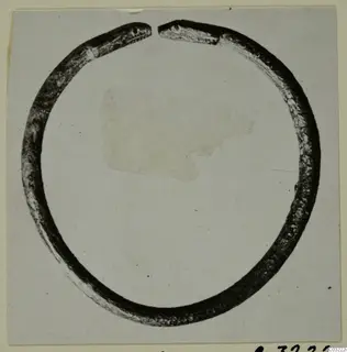 Single dark metal ring with an open gap at the top, photographed on a card mount. Marion Tomb 60.
