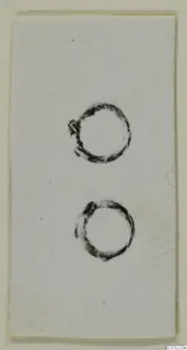 Two ring-shaped objects shown on a white card, from the Marion finds of tombs 31–45