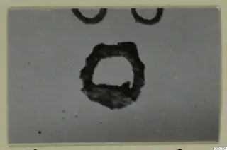 Ring-shaped objects from Marion, close view on a pale ground, with rings cut off at the top edge