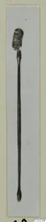 Bronze toilet implement from Marion, Tomb 55: a long slender rod with a flattened, corroded head at the upper end