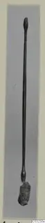 Long slender bronze toilet implement from Marion, Tomb 55, with a knobbed top end and a corroded lump at the base
