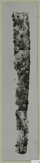 Corroded iron tool or knife fragment from Marion Tomb 56, shown upright in several joined pieces.