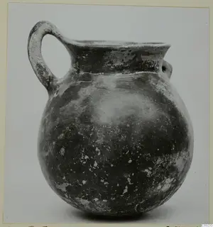Pottery Red Polished III jug with a strap handle, from Lapithos