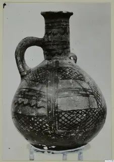 Pottery jug with a strap handle and dark painted bands, a find from the Vrysi tou Barba tombs at Lapithos