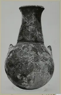 Black Polished pottery vessel with a long neck, two small lugs and incised chevron and lozenge patterns