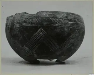 Black Polished bowl from Lapithos with incised chevron and banded decoration, standing on three small feet