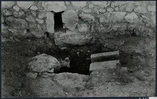 Excavated stones at Vouni palace, with a stone wall above a dug hollow in the ground