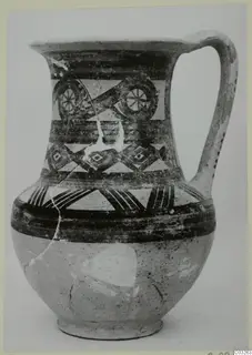 Pottery Bichrome Wheel-made jug from Milia, with painted bands and roundel motifs on the neck